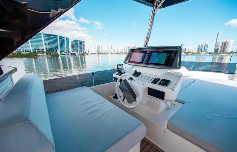 Our Trade Yacht Photos Pics Luxurious 2022 Ferretti Yachts 670 helm with city skyline view.