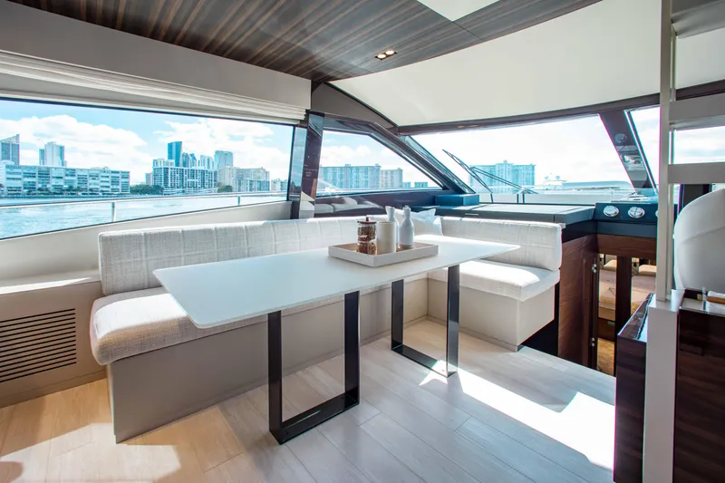 Our Trade Yacht Photos Pics Luxurious interior of 2022 Ferretti Yachts 670 with modern dining area and cityscape view.