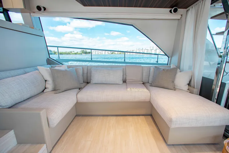 Our Trade Yacht Photos Pics Luxurious interior of 2022 Ferretti Yachts 670 with plush seating and scenic water view.