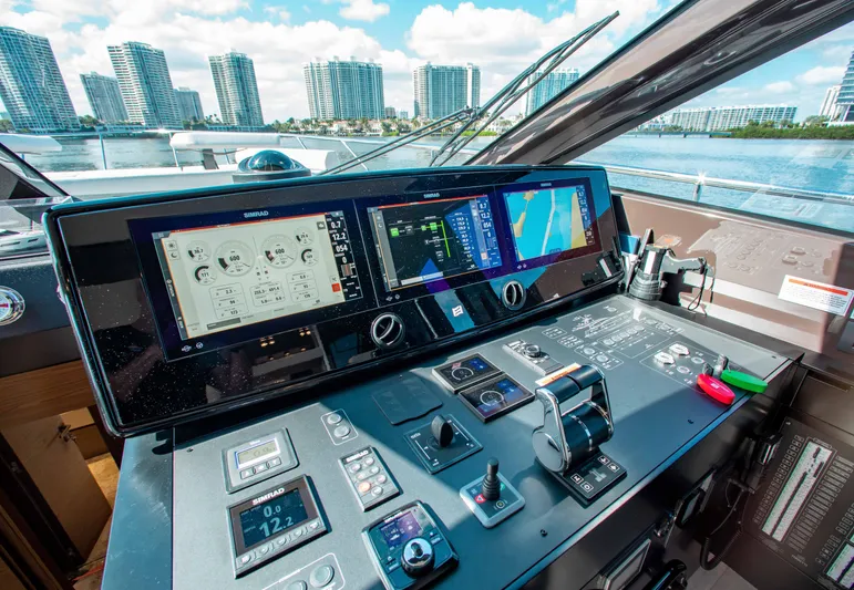 Our Trade Yacht Photos Pics Control panel of 2022 Ferretti Yachts 670 with city skyline in background.