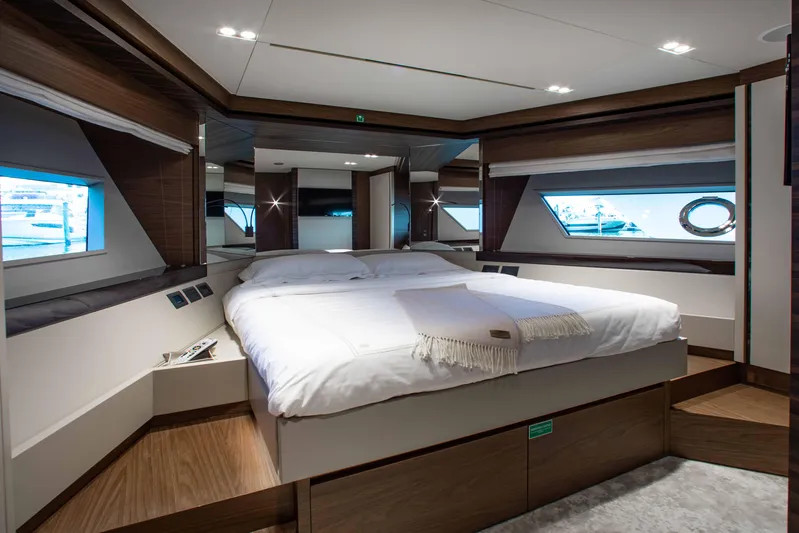 Our Trade Yacht Photos Pics Luxurious bedroom interior of 2022 Ferretti Yachts 670 with modern design and large windows.