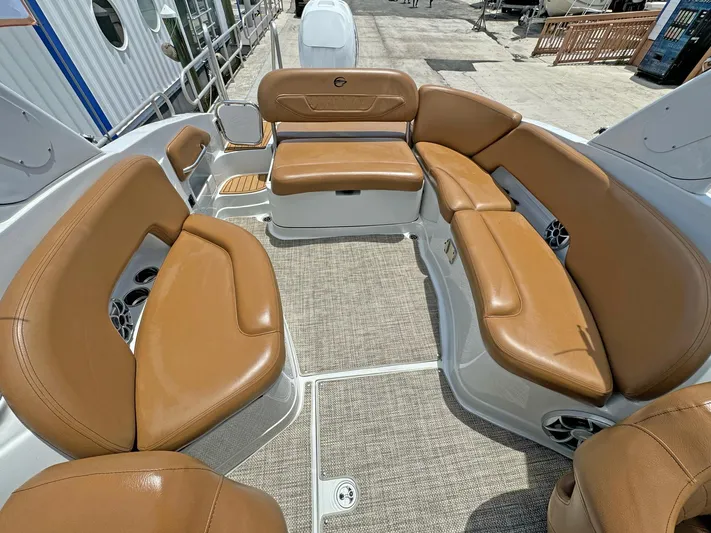  Yacht Photos Pics 2024 Crownline 290 XSS boat interior with tan leather seating and carpeted flooring.
