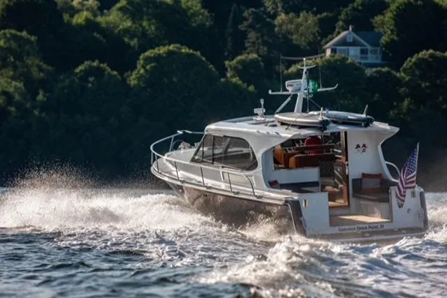  Yacht Photos Pics 2018 Hylas M44 yacht cruising on a scenic waterway with lush greenery.
