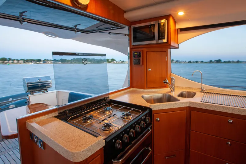  Yacht Photos Pics Luxurious 2018 Hylas M44 yacht kitchen with stove, sink, and scenic water view.