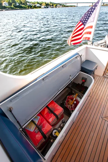  Yacht Photos Pics 2018 Hylas M44 yacht deck with storage compartment, American flag, and scenic water view.