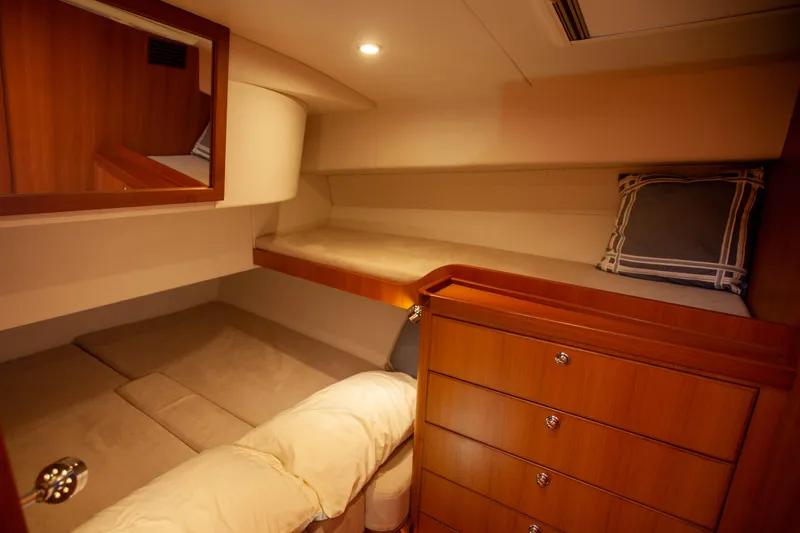  Yacht Photos Pics Cozy cabin interior of 2018 Hylas M44 yacht with wooden drawers and soft bedding.