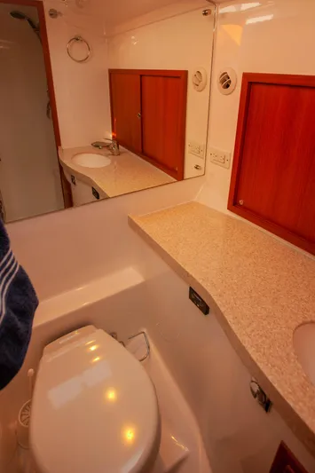  Yacht Photos Pics Bathroom interior of 2018 Hylas M44 yacht with modern fixtures and wooden cabinetry.