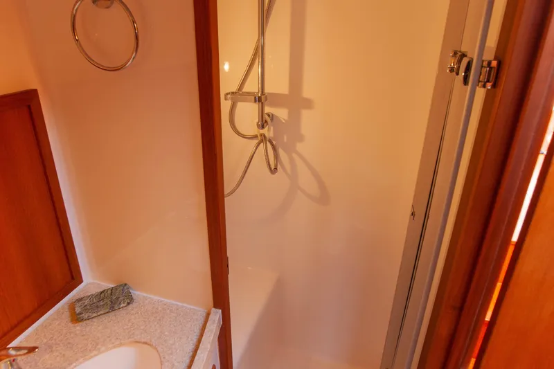  Yacht Photos Pics Shower area in 2018 Hylas M44 yacht with modern fixtures and wooden accents.