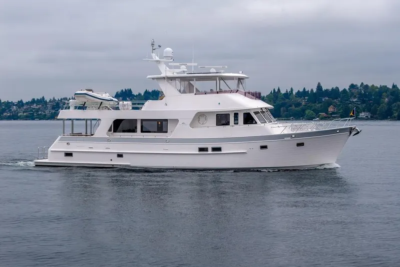 Smile Smile Smile Yacht Photos Pics 2022 Outer Reef 720 Motor Yacht cruising on a calm lake under cloudy skies.