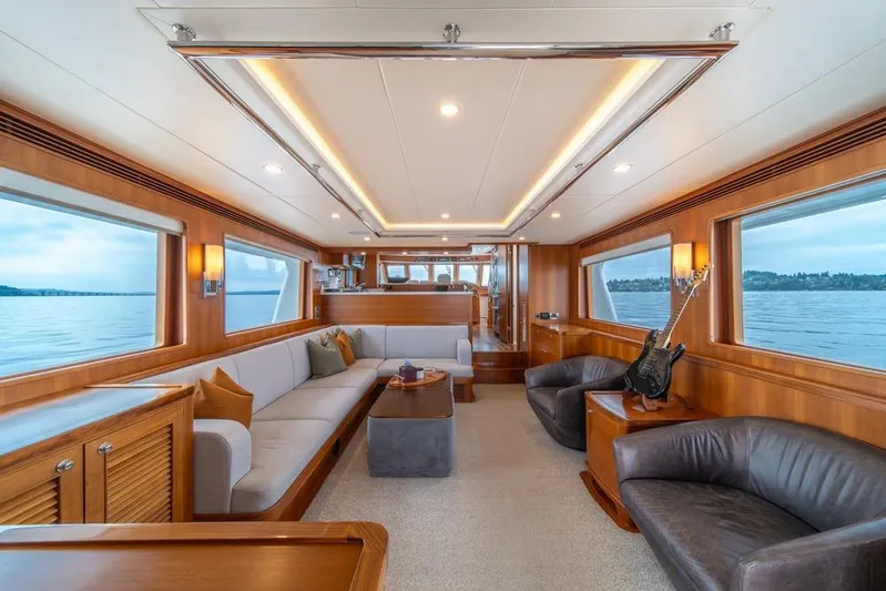 Smile Smile Smile Yacht Photos Pics Luxurious interior of 2022 Outer Reef 720 Motor Yacht with elegant seating and panoramic windows.