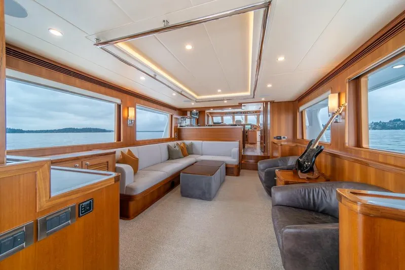 Smile Smile Smile Yacht Photos Pics Luxurious interior of 2022 Outer Reef 720 Motor Yacht with elegant seating and panoramic windows.