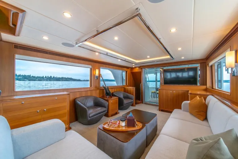 Smile Smile Smile Yacht Photos Pics Luxurious interior of 2022 Outer Reef 720 Motor Yacht with elegant seating and scenic views.