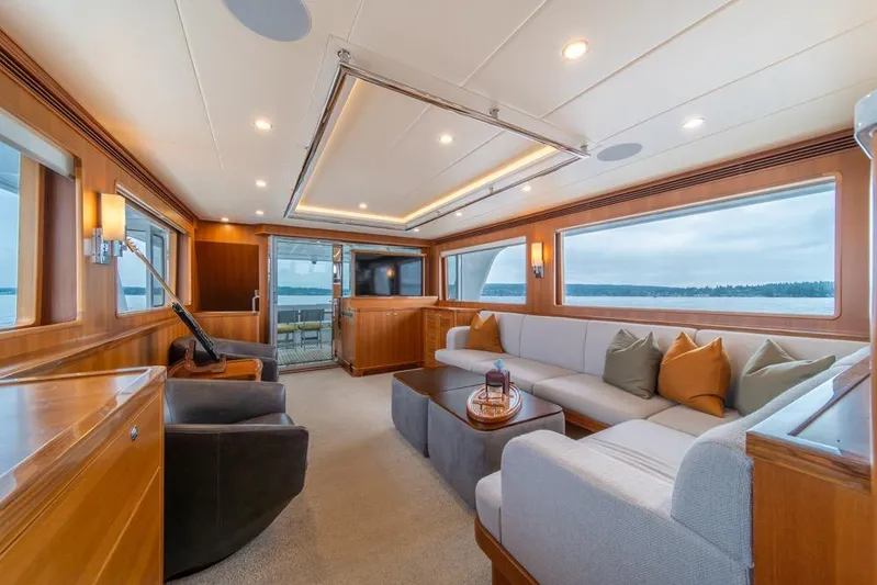 Smile Smile Smile Yacht Photos Pics Luxurious interior of 2022 Outer Reef 720 Motor Yacht with elegant seating and panoramic windows.