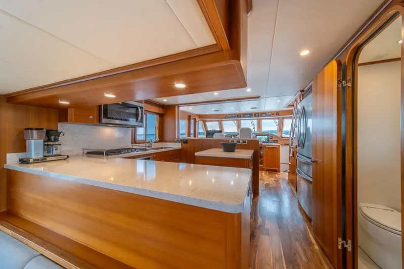 Smile Smile Smile Yacht Photos Pics Luxurious kitchen interior of 2022 Outer Reef 720 Motor Yacht with modern amenities.