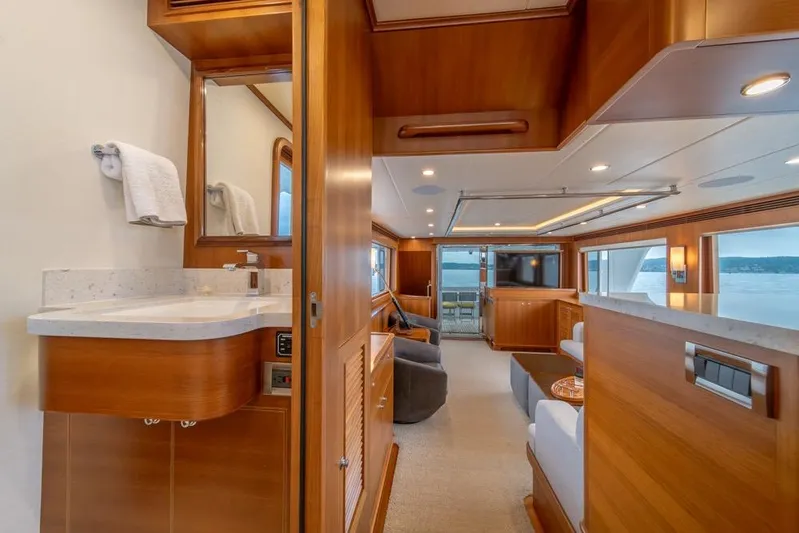 Smile Smile Smile Yacht Photos Pics Luxurious interior of 2022 Outer Reef 720 Motor Yacht with elegant wood finishes.