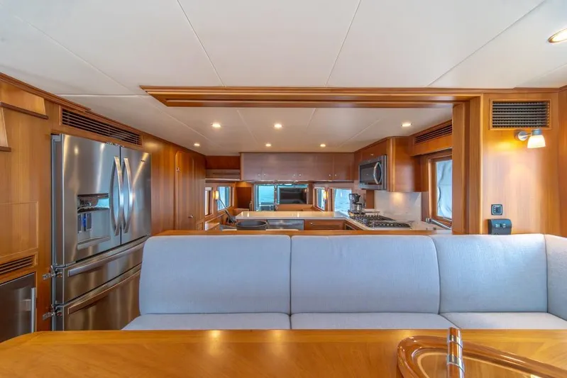 Smile Smile Smile Yacht Photos Pics Luxurious interior of 2022 Outer Reef 720 Motor Yacht with modern kitchen and elegant wood finishes.