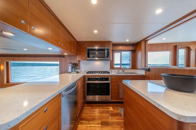 Smile Smile Smile Yacht Photos Pics Luxurious kitchen interior of 2022 Outer Reef 720 Motor Yacht with modern appliances.