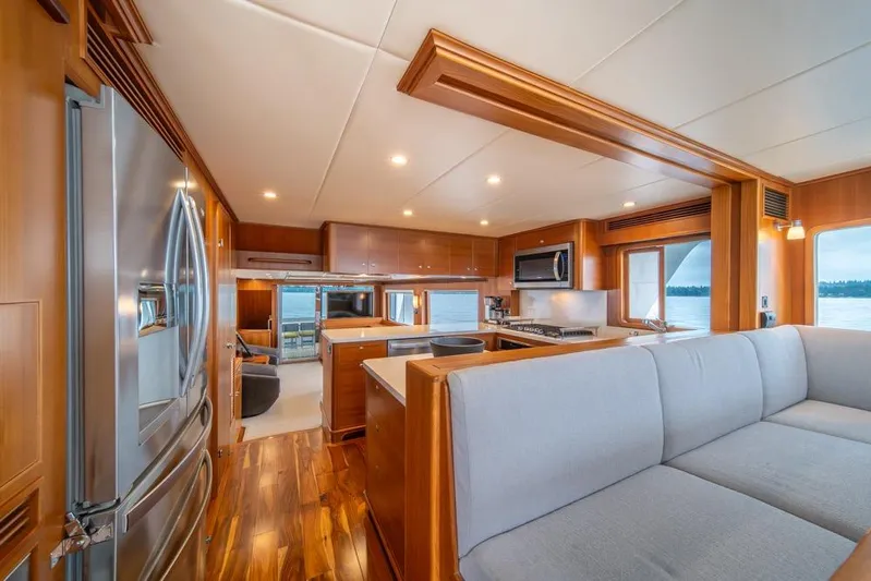 Smile Smile Smile Yacht Photos Pics Luxurious interior of 2022 Outer Reef 720 Motor Yacht with modern kitchen and seating area.