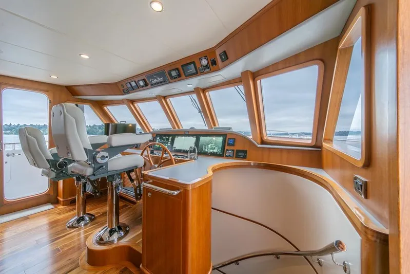 Smile Smile Smile Yacht Photos Pics Luxurious helm of 2022 Outer Reef 720 Motor Yacht with panoramic windows and modern controls.