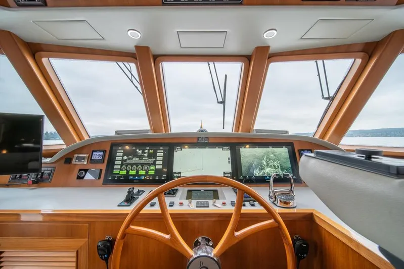 Smile Smile Smile Yacht Photos Pics Cockpit of 2022 Outer Reef 720 Motor Yacht with advanced navigation displays.