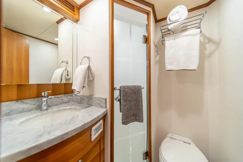 Smile Smile Smile Yacht Photos Pics Luxurious bathroom in 2022 Outer Reef 720 Motor Yacht with marble countertop and modern fixtures.