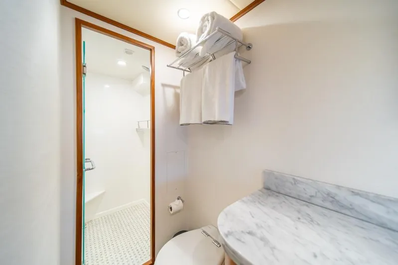 Smile Smile Smile Yacht Photos Pics Luxurious bathroom in 2022 Outer Reef 720 Motor Yacht with marble countertop and shower.