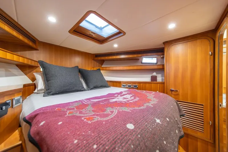 Smile Smile Smile Yacht Photos Pics Luxurious cabin interior of 2022 Outer Reef 720 Motor Yacht with cozy bedding.