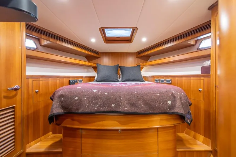 Smile Smile Smile Yacht Photos Pics Luxurious cabin interior of 2022 Outer Reef 720 Motor Yacht with wooden finish.