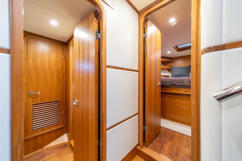 Smile Smile Smile Yacht Photos Pics Luxurious interior of 2022 Outer Reef 720 Motor Yacht with wooden doors and cozy cabin.