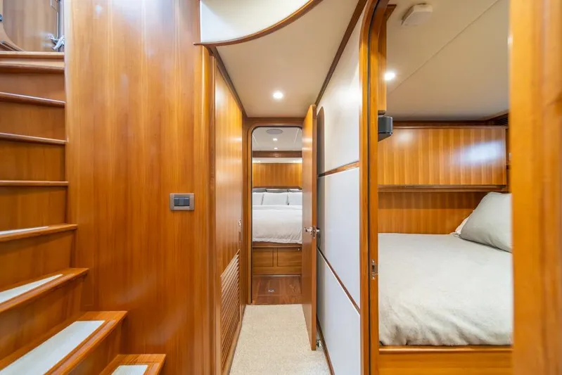 Smile Smile Smile Yacht Photos Pics Luxurious interior of 2022 Outer Reef 720 Motor Yacht with wooden finishes and cozy bedrooms.