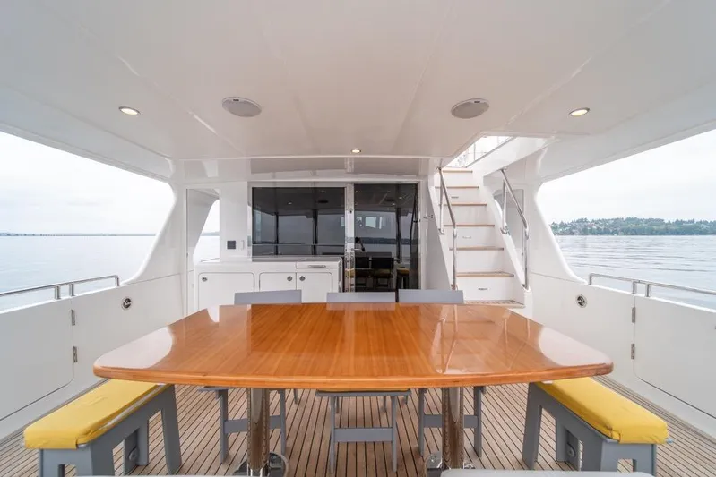 Smile Smile Smile Yacht Photos Pics Luxurious 2022 Outer Reef 720 Motor Yacht with elegant outdoor dining area.