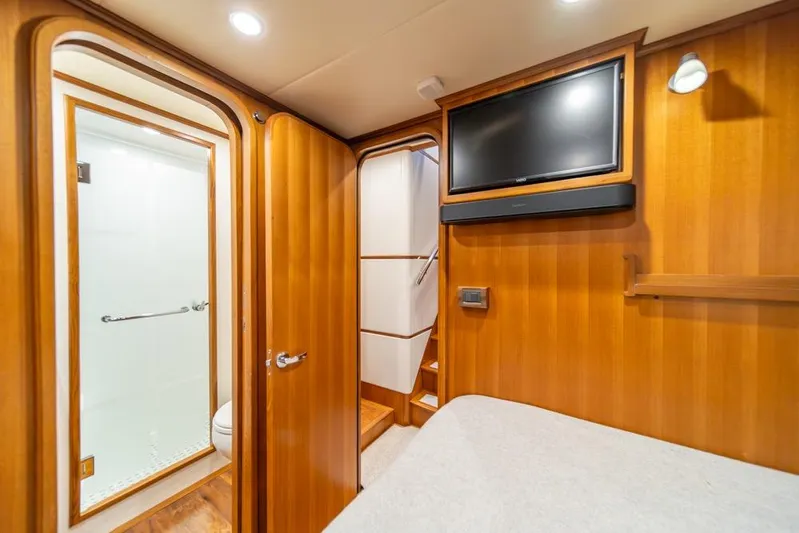 Smile Smile Smile Yacht Photos Pics Luxurious interior of 2022 Outer Reef 720 Motor Yacht with wood paneling and modern amenities.