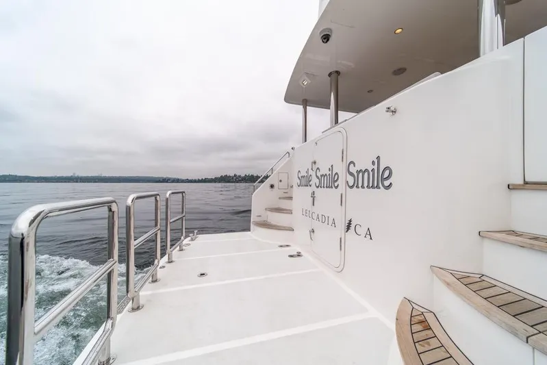 Smile Smile Smile Yacht Photos Pics Outer Reef 720 Motor Yacht 2022, rear deck view with ocean backdrop.