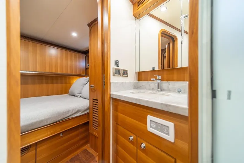 Smile Smile Smile Yacht Photos Pics Luxurious cabin interior of 2022 Outer Reef 720 Motor Yacht with wood finish and modern amenities.