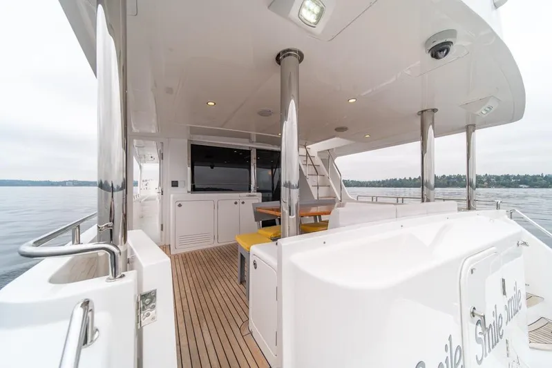 Smile Smile Smile Yacht Photos Pics 2022 Outer Reef 720 Motor Yacht deck with seating and ocean view.