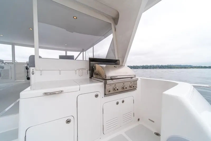 Smile Smile Smile Yacht Photos Pics Outdoor kitchen on 2022 Outer Reef 720 Motor Yacht with stainless steel grill.