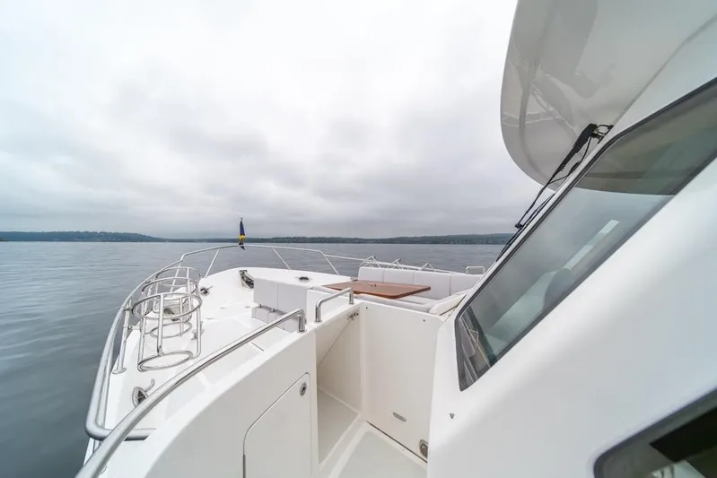 Smile Smile Smile Yacht Photos Pics 2022 Outer Reef 720 Motor Yacht on calm waters under cloudy skies.