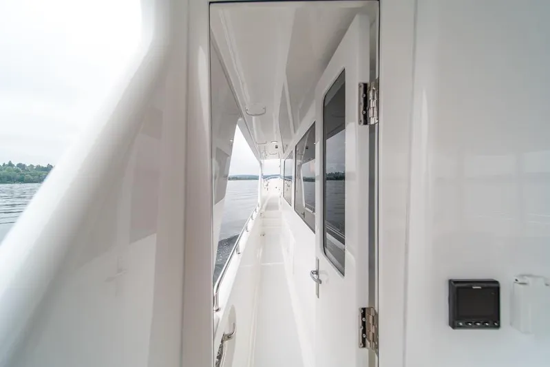 Smile Smile Smile Yacht Photos Pics Outer Reef 720 Motor Yacht 2022, sleek white exterior, side deck view, calm waters.