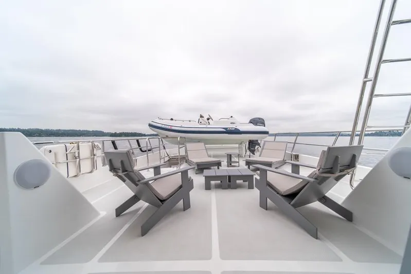 Smile Smile Smile Yacht Photos Pics 2022 Outer Reef 720 Motor Yacht deck with seating and tender boat.