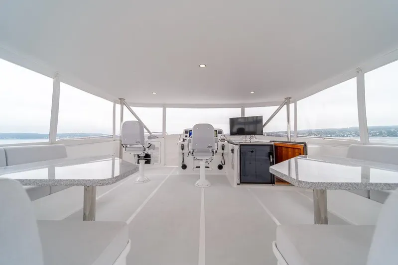 Smile Smile Smile Yacht Photos Pics Spacious helm area of 2022 Outer Reef 720 Motor Yacht with modern seating and navigation equipment.