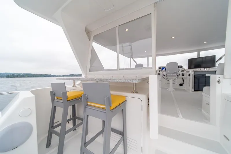 Smile Smile Smile Yacht Photos Pics 2022 Outer Reef 720 Motor Yacht interior with seating and helm station.