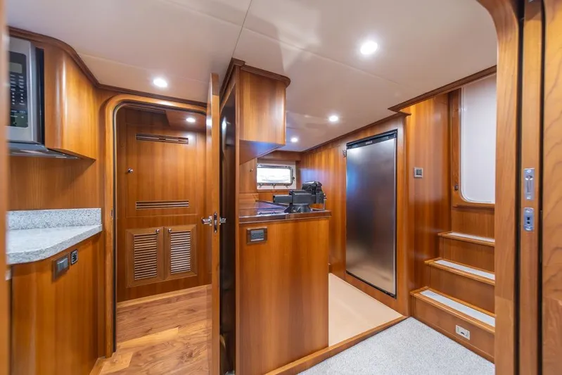 Smile Smile Smile Yacht Photos Pics Luxurious interior of 2022 Outer Reef 720 Motor Yacht with wood finishes and modern amenities.