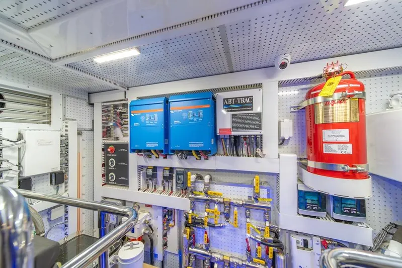 Smile Smile Smile Yacht Photos Pics Engine room of 2022 Outer Reef 720 Motor Yacht with electrical panels and fire extinguisher.