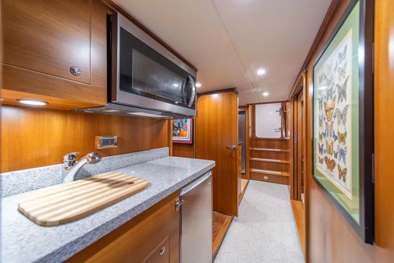 Smile Smile Smile Yacht Photos Pics Luxurious interior of 2022 Outer Reef 720 Motor Yacht with modern kitchen amenities.