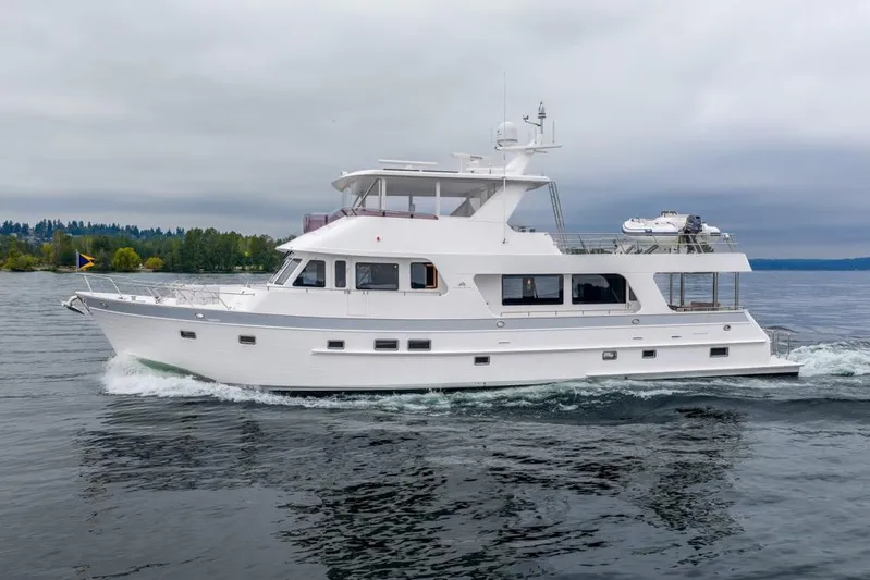 Smile Smile Smile Yacht Photos Pics 2022 Outer Reef 720 Motor Yacht cruising on calm waters under cloudy skies.