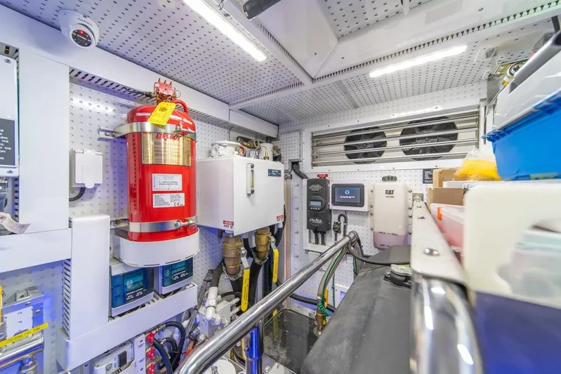 Smile Smile Smile Yacht Photos Pics Engine room of 2022 Outer Reef 720 Motor Yacht with fire extinguisher and control systems.
