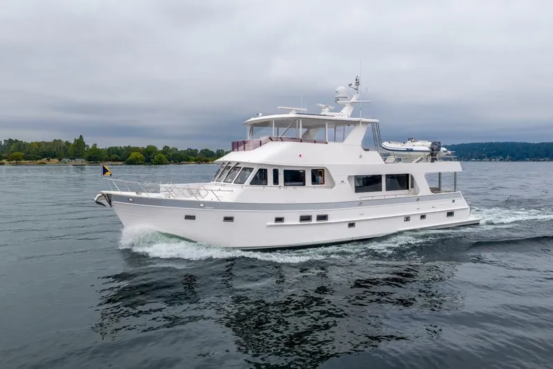 Smile Smile Smile Yacht Photos Pics 2022 Outer Reef 720 Motor Yacht cruising on calm waters under cloudy skies.