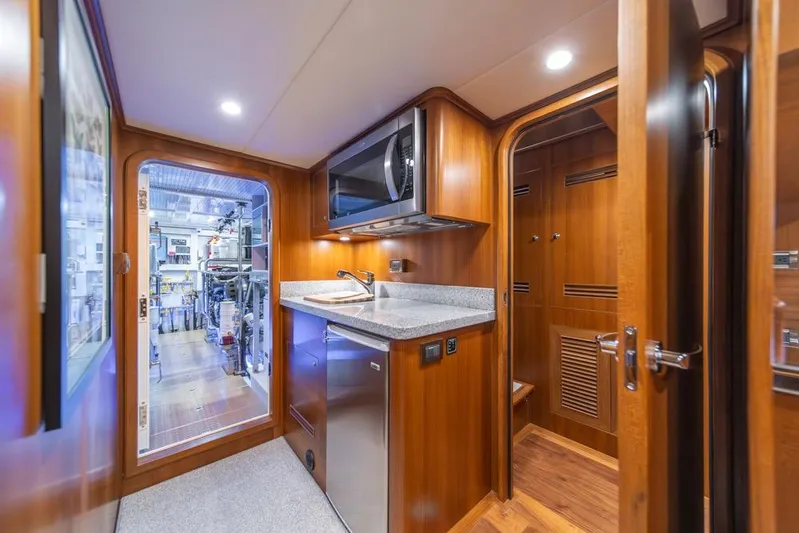 Smile Smile Smile Yacht Photos Pics Interior of 2022 Outer Reef 720 Motor Yacht with kitchenette and engine room access.