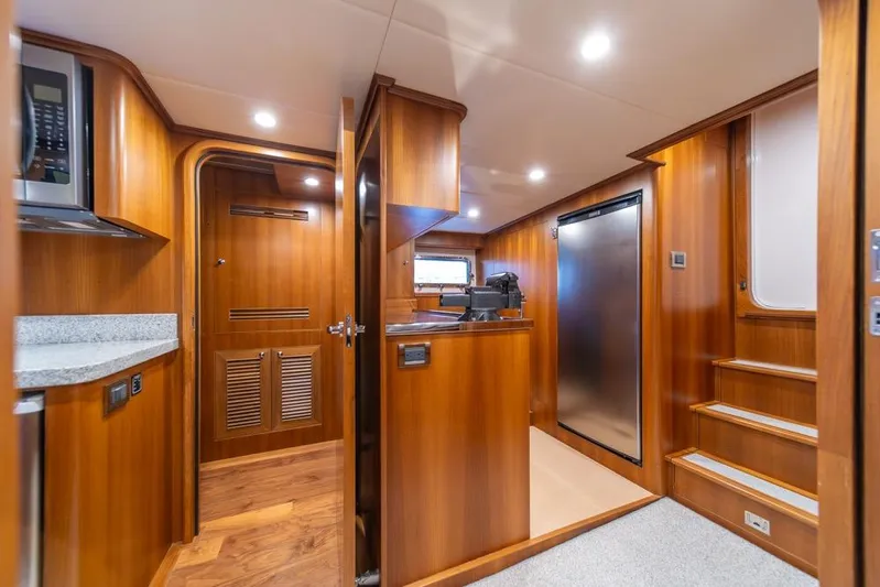 Smile Smile Smile Yacht Photos Pics Luxurious interior of 2022 Outer Reef 720 Motor Yacht with wood finishes and modern amenities.