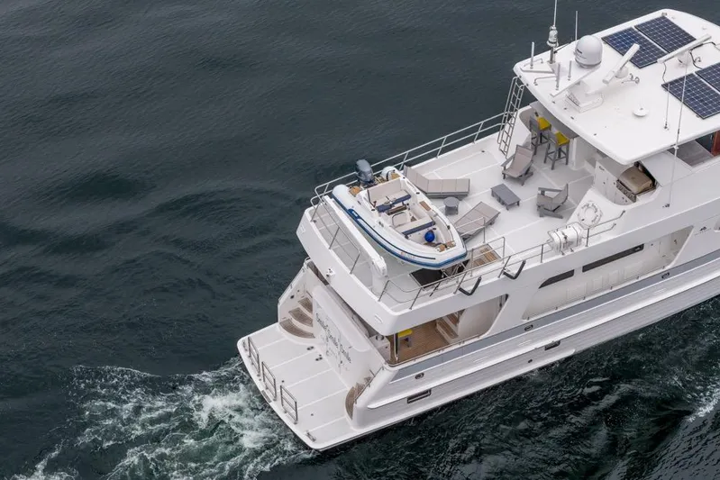 Smile Smile Smile Yacht Photos Pics Aerial view of 2022 Outer Reef 720 Motor Yacht cruising on open water.